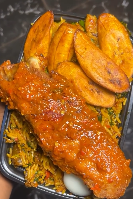 Native rice (red oil rice) with kpanla, ponmo, dry fish, boiled egg, plantain & Turkey